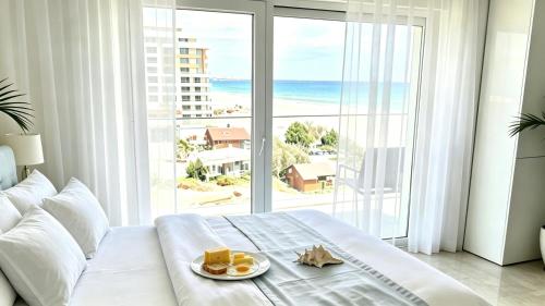 a bedroom with a bed with a view of the ocean at White Tower Mamaia Beach 505 in Mamaia