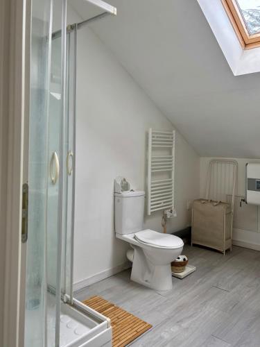 a bathroom with a toilet and a glass shower at Monet Garden Retreat in Giverny