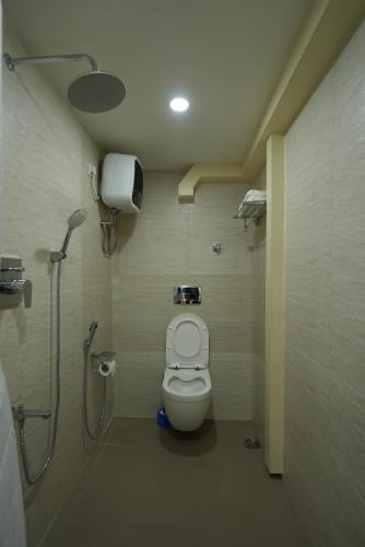 a bathroom with a shower and a toilet in a room at Hotel Quality Inn in Āīzawl