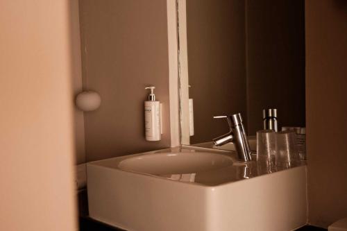 a bathroom with a sink and a mirror at Hôtel De La Vallée in Dinard