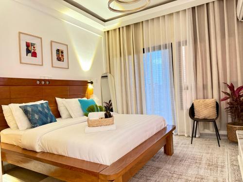 a bedroom with a large bed and a window at Julianah appart in Douala