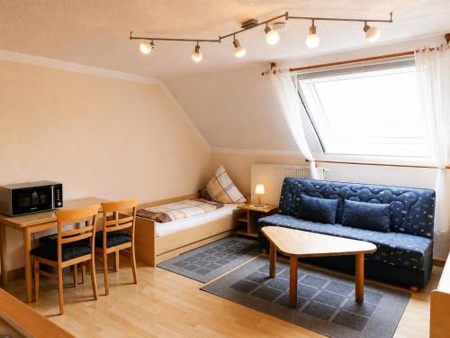 a living room with a couch and a table at Einzelzimmer in Kelheim