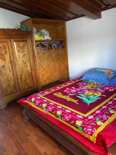 a bed with a colorful blanket on it in a room at pti caze Hoarau in Le Tampon