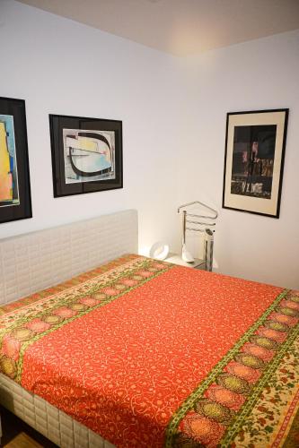 a bedroom with a bed and two pictures on the wall at Mainresidenz Wertheim in Wertheim