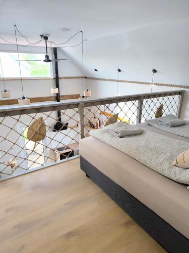 a bedroom with a bed and a railing at #MazuryOFFline in Giżycko