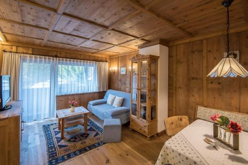 a living room with a blue couch and a table at Haus Andreas in Seefeld in Tirol