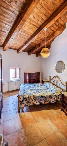 a bedroom with a bed and a wooden ceiling at Liana's home in Gallo
