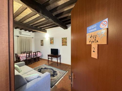 a living room with a couch and a door with a sign on it at Agriturismo Aggazzotti in Colombaro