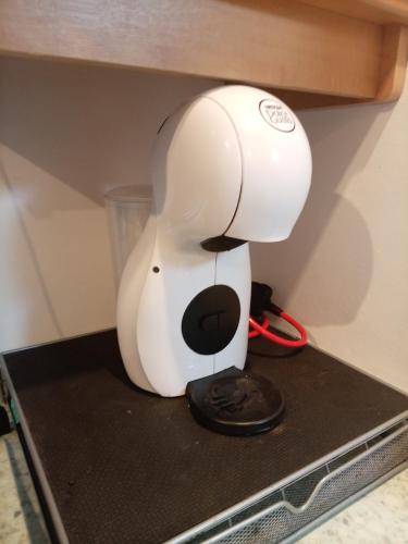 a white mixer sitting on top of a shelf at Sandgate retreat hemsby 2023 in Hemsby
