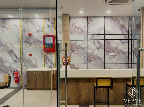 a lobby with a wall covered in marble at IPOH AVS HOTEL by VERVE in Ipoh