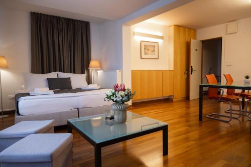a hotel room with a bed and a coffee table at Hotel Creina in Kranj