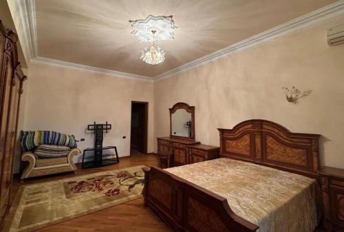 a bedroom with a bed and a mirror and a chandelier at Sirik guest house in Geghanist