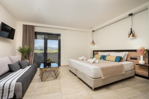 a bedroom with a bed and a couch at Moon Boutique Hotel - Ultra Luxury Suites with Pool, Perfect for Fun and Relaxation By Villa Mana Gers in Laganas