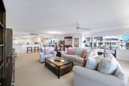 a living room with two couches and a coffee table at Beachcomber A101 in Sanibel