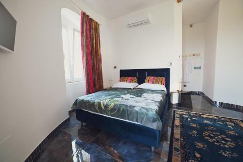a bedroom with a bed and a large window at Torre Biancaluna in Vico del Gargano