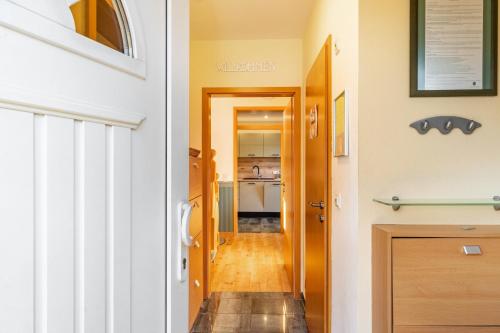 a hallway with a door leading to a kitchen at Ferienhaus Gut Düneburg in Haren