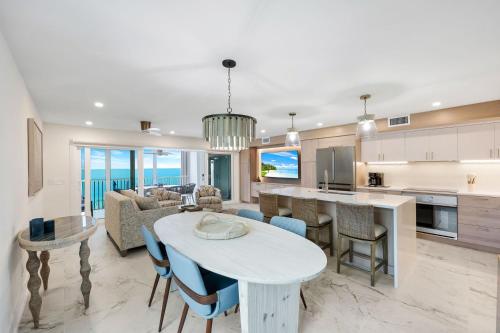 a kitchen and living room with a table and chairs at Captiva Hide A Way 1B in Captiva