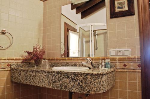 a bathroom with a sink and a mirror at Posada Real El Sendero del Agua in Trefacio