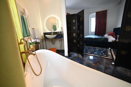 a bathroom with a bath tub and a sink at Torre Biancaluna in Vico del Gargano