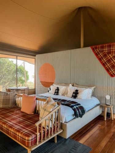 a bedroom with a bed and a couch in a room at Camp Canoe in Franschhoek