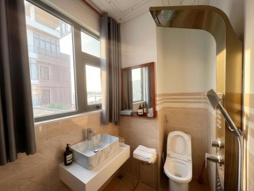 a bathroom with a sink and a toilet at Mimosa 8 Hotel - Ninh Chử in Ninh Hải