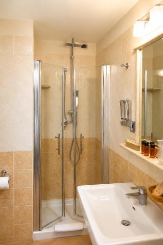 a bathroom with a shower and a sink at Hotel Villa Gustui Maris in Cala Gonone