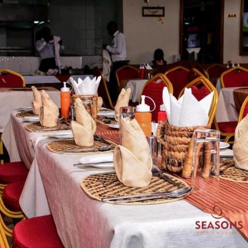 a table with white clothed tables with baskets on it at Seasons Airport Hotel Nairobi in Nairobi