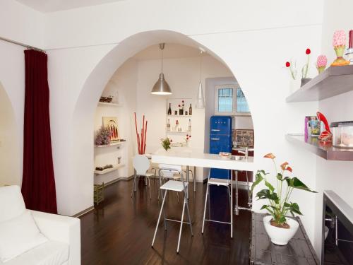 a kitchen and living room with an archway and a table at Trastevere Art House in Rome