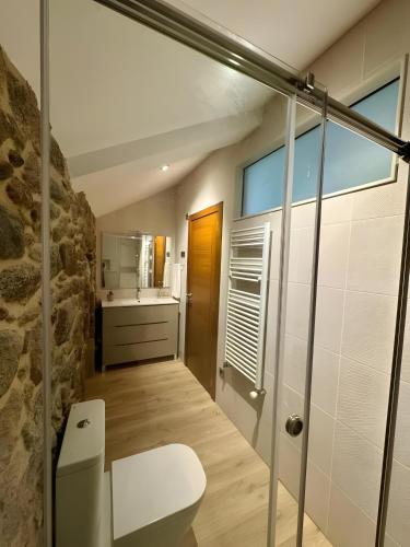 a bathroom with a toilet and a sink at Mar Do Val in Muxia