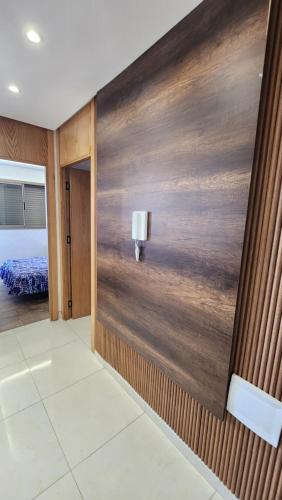a room with a wooden wall with a light on it at Sidi Rahal in Sidi Rahal