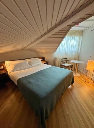 a bedroom with a large bed with a ceiling at Hotel Terradets in Cellers