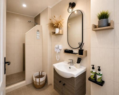 a bathroom with a sink and a mirror at Mare Nostrum Santo in Oia
