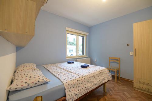 a bedroom with a bed with a table and a window at Nostromo in Kotor