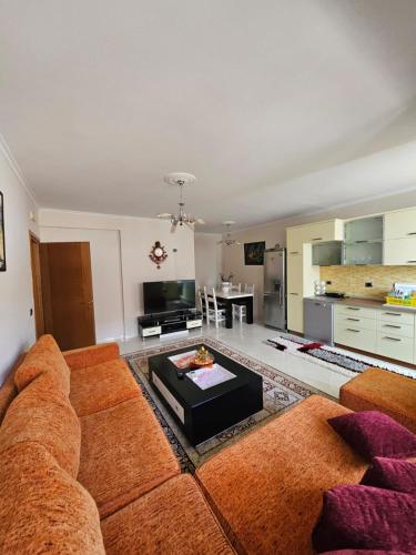 a living room with a couch and a table at SunBeach Apartament in Golem