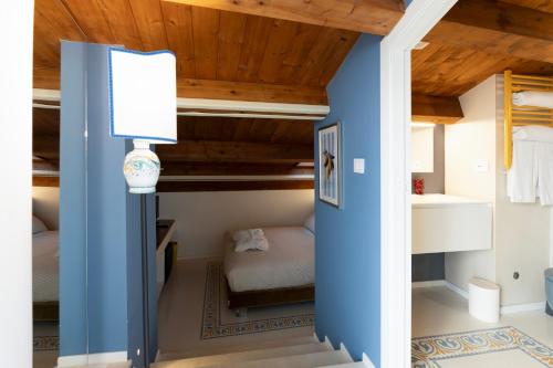 a bedroom with blue walls and a bunk bed at Rial Collection Luxury Suite in Syracuse