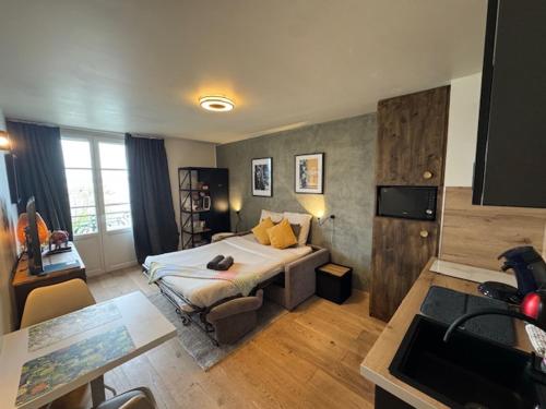 a hotel room with a bed and a kitchen at Le Chaplin face au lac Léman in Évian-les-Bains