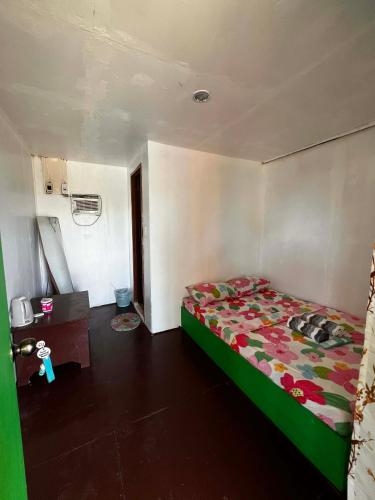 a bedroom with a bed with a colorful comforter at Scott's Seaview Resort in Idanao