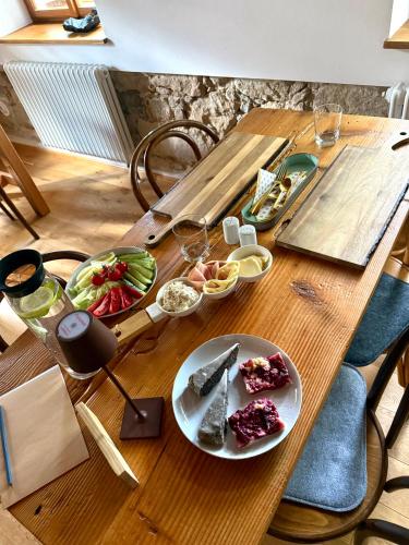 a wooden table with a plate of food on it at Fajn TAJM Rychleby in Černá Voda