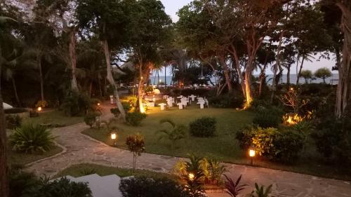 an image of a garden at night with lights at Ocean Village Club (Adults Only) in Diani Beach