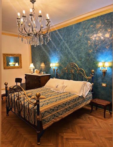 a bedroom with a bed and a chandelier at B&B Dai Toscans in Cividale del Friuli