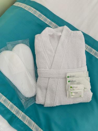 a white towel and a heart on a blue blanket at Marina House in Sulina