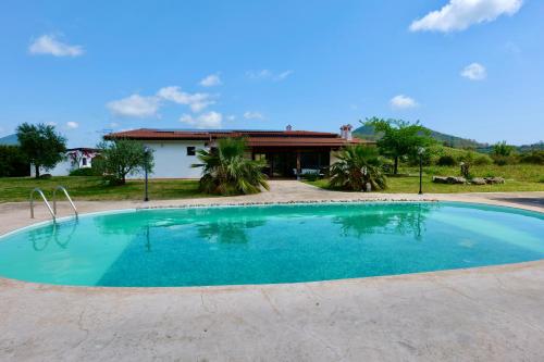 a large swimming pool in front of a house at Villa IS CARCURIS Jennas in Cardedu