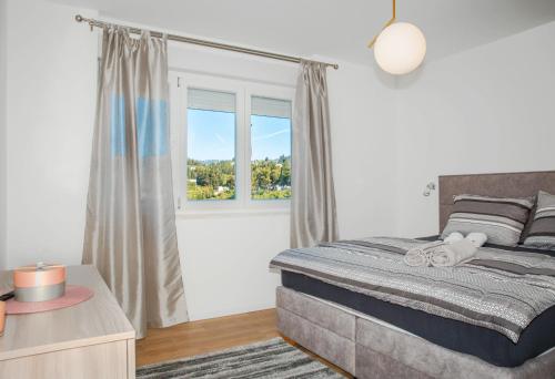 a bedroom with a large bed and a window at Apartment Matko in Ploče