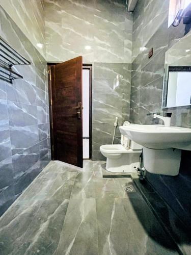 a bathroom with a sink and a toilet at Vish Homes in Nallur