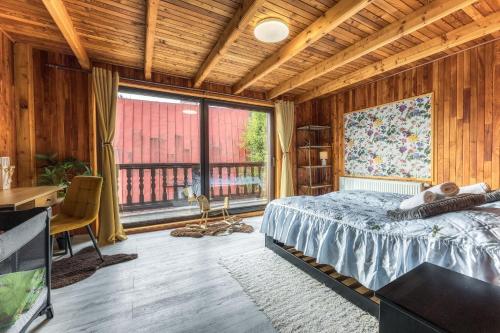 a bedroom with a bed and a large window at Anna Sela in Vrbov
