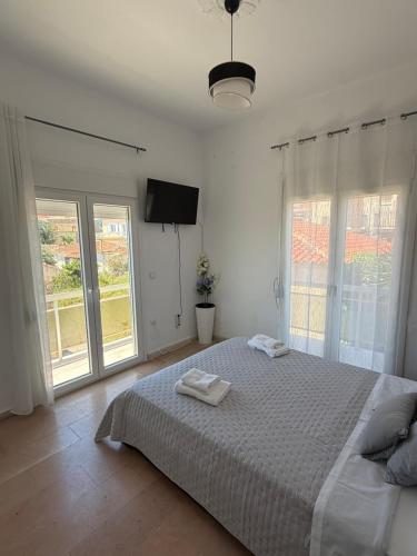 a bedroom with a bed with two towels on it at METHONI LUXURY House in Methoni