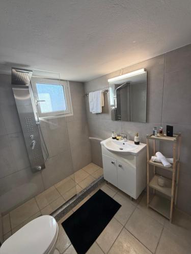 a bathroom with a white toilet and a sink at METHONI LUXURY House in Methoni