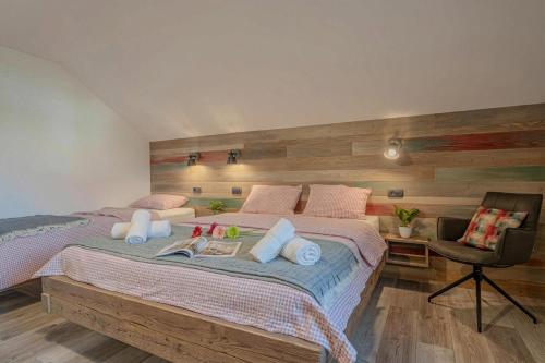 a bedroom with a large bed and a chair at Lukec Estate in Kostel