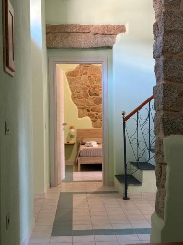 a hallway with a door leading to a bedroom at La Gradinata in Gonnosfanàdiga