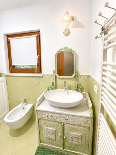 a bathroom with a sink and a mirror at Al Vagone in La Salle